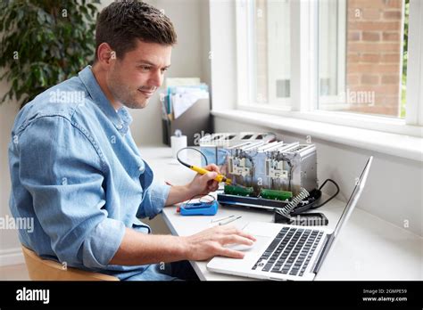 Man Fixing Electric Toaster Using Online Instructions Rather Than