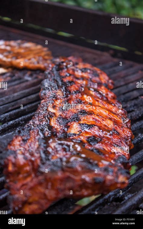 Grilling Pork Loin Ribs On A Gas Barbeque Stock Photo Alamy