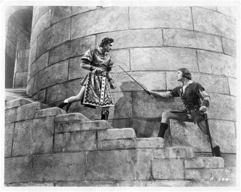 An Old Black And White Photo Of Two People On Steps Near A Stone Castle