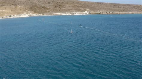 Wind surfers in action. Aerial view of speeding windsurfers. A ...