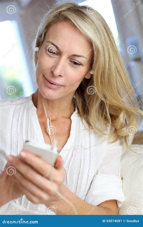 Mature Woman Using Earphones Talking On The Phone Stock Image Image