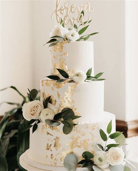 White And Gold Wedding Cake With Greenery