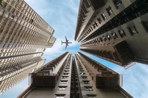 Premium Photo Directly Below Shot Of Airplane Flying Over Buildings