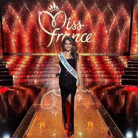 miss france contestant walks down the catwalk in front of a stage with ...