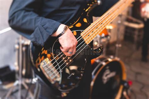 Concert View Of A Musician Electric Bass Guitar Player With During