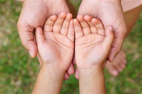 Mãe e filho de mãos dadas para receber algo Foto Premium