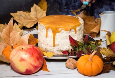 A Cake Sitting On Top Of A White Plate Covered In Caramel Icing Next To