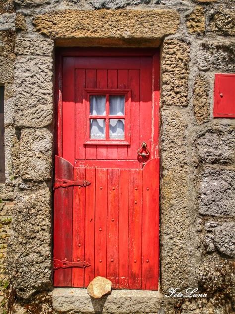 An Old Red Door With Two Windows On It