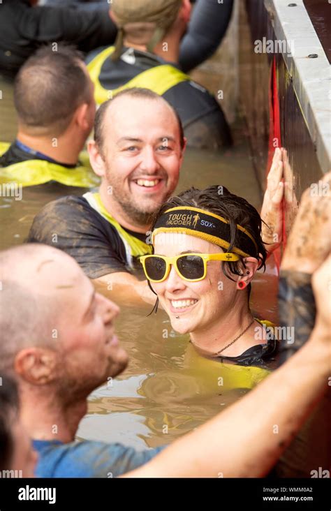 Contestants In The ‘block Ness Monster Obstacle At The Tough Mudder