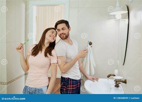 Couple In The Morning Personal Hygiene In The Bathroom Stock Image