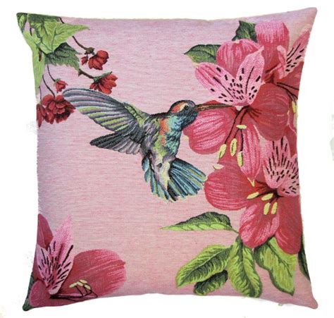 A Pink Pillow With A Hummingbird And Flowers On It