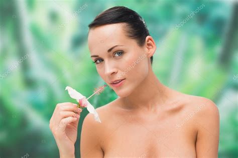 Beautiful Nude Brunette Smelling Lily Looking At Camera Stock Photo By