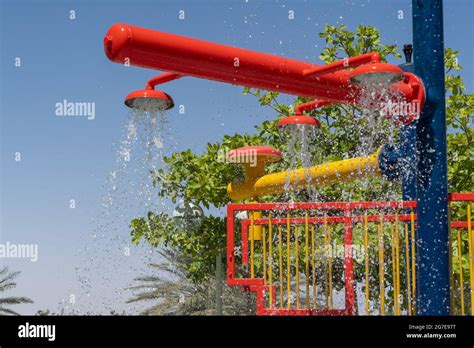 Three Red Fountain Spray Water Park Sprinklers Spraying Water Above For