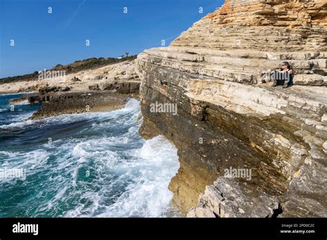 woman lying on the rocks of Cape Kamenjak, a protected natural area on the southern tip of the ...