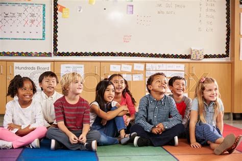 Elementary school kids sitting on ... | Stock image | Colourbox