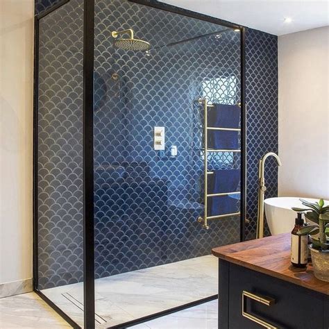 A Bathroom With A Glass Shower Door And Wooden Counter Top Next To A