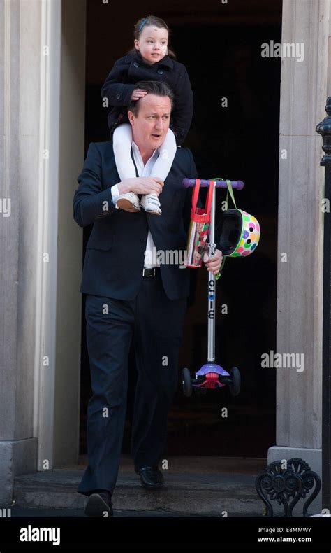 David Cameron leaves Downing Street carrying his daughter Nancy on his ...