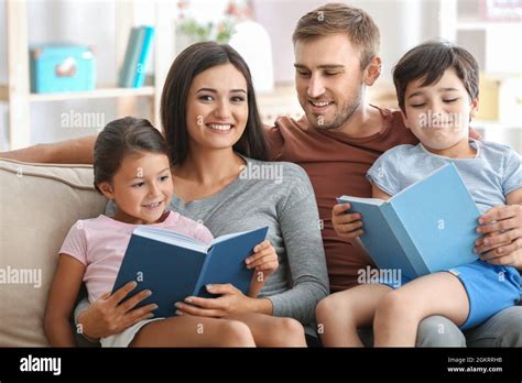 Happy family reading books at home Stock Photo - Alamy