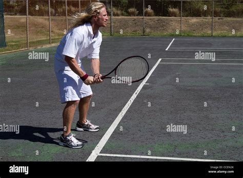 A Blonde Male Tennis Player Concentrates As He Prepares To Return The Serve Stock Photo Alamy