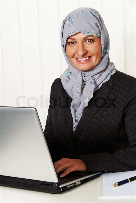 Muslim Woman Wearing A Headscarf In The Office At Work Stock Image