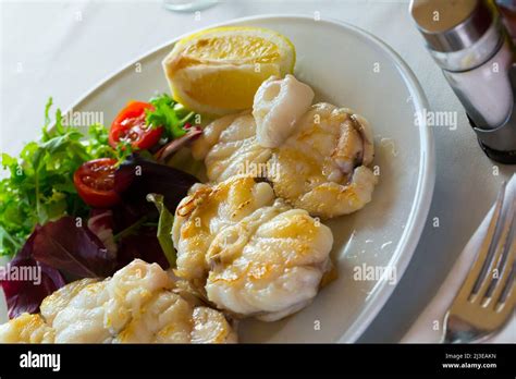 Grilled Monkfish Cherry Tomatoes And Lemon Stock Photo Alamy