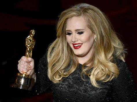 Singer Adele Adkins accepts the Best Original Song award for... Photo