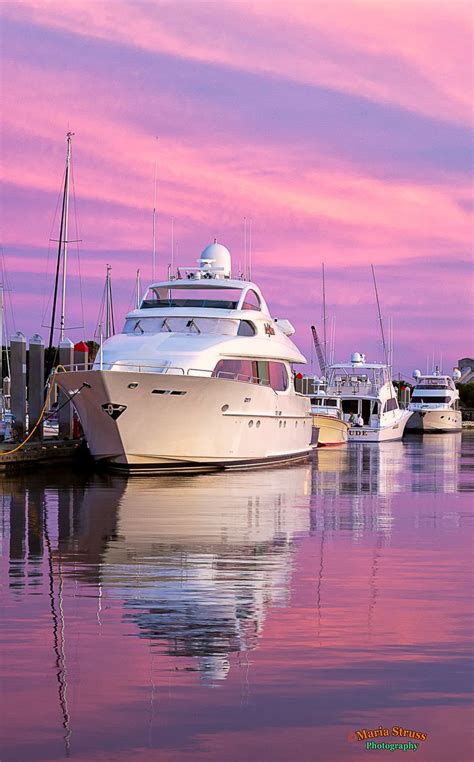 A picture of boats docked at the Harbor Marina in downtown Fernandina Beach, Florida as the sky ...