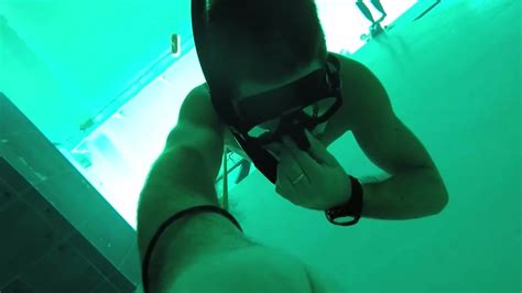 Freediver Breatholding Underwater In Speedos