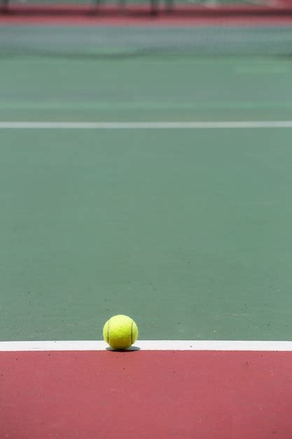 Premium Photo Tennis Ball On The Court