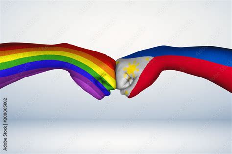 Fist bump of Filipino flag and Pride Flag. Two hands with painted flags ...