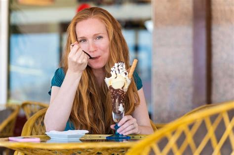 Premium Photo Redhead Woman Having A Glass Of Ice Cream On A Terrace