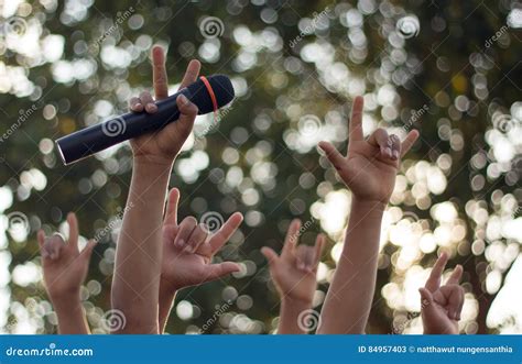 Hand Holding a Single Microphone Against Colourful Background,singing ...