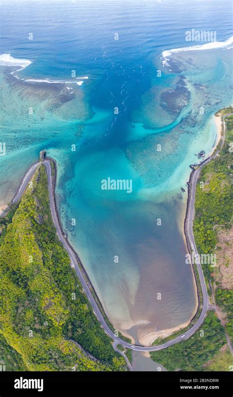 Coastal road facing the turquoise lagoon, aerial view by drone, Bel ...