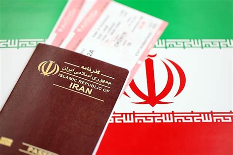 Premium Photo Red Islamic Republic Of Iran Passport With Airline Tickets On Iranian Flag