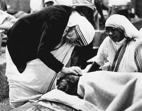 Mother Teresa Attends To A Patient In Her Home For The Dying In