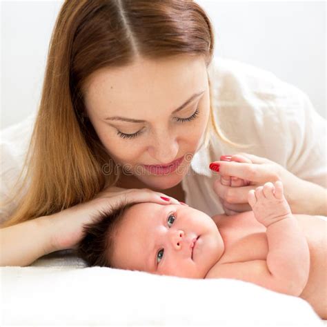 Young Beautiful Mother Breastfeeding Her Newborn Baby Boy Stock Photo