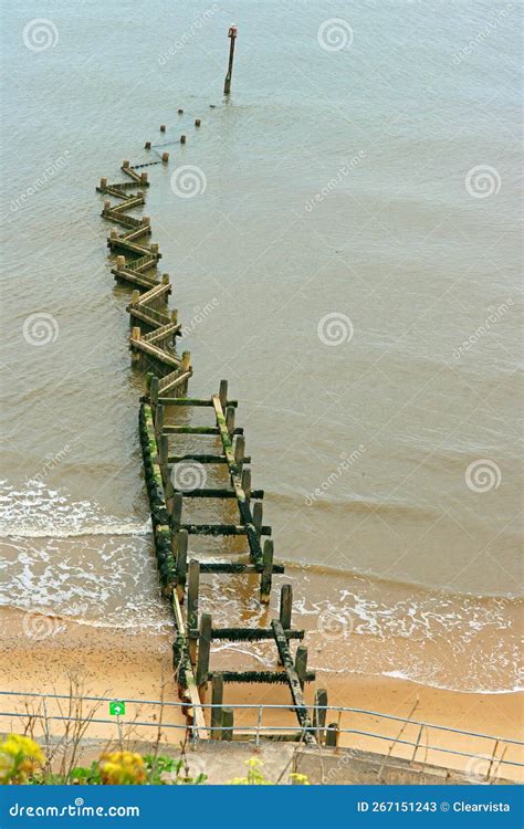 Wooden Groyne On Cleethorpes Beach With Wind Turbines In The Distance