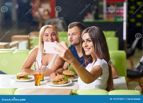 Young Girl Taking Selfie Together With Happy Friends Stock Image