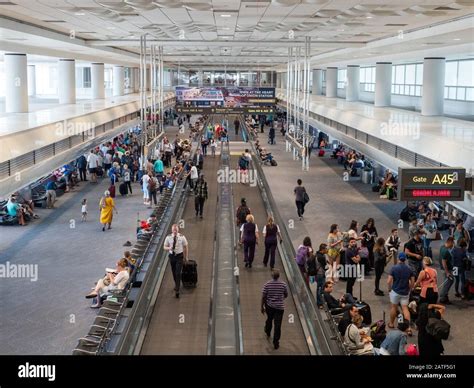 Pilots Workers And Passengers In A Busy Airport Terminal With Moving