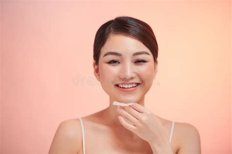 Closeup Portrait Of Beautiful Healthy Girl With Nude Makeup Cleaning Perfect Soft Skin With Oil