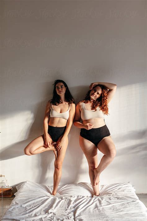 Two Friends Wearing Underwear Over A Bed By Stocksy Contributor Marc