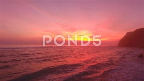 Sunset On A Paradise Island By Ocean Waves Washing Indonesia Bali