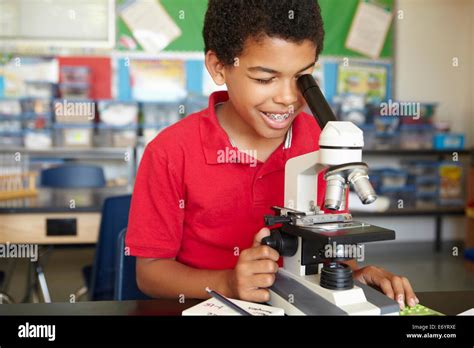 Boy In Science Class With Microscope Stock Photo Alamy