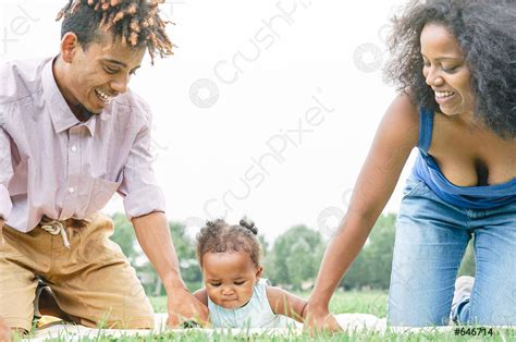 Happy African family having fun doing picnic in public park - stock ...