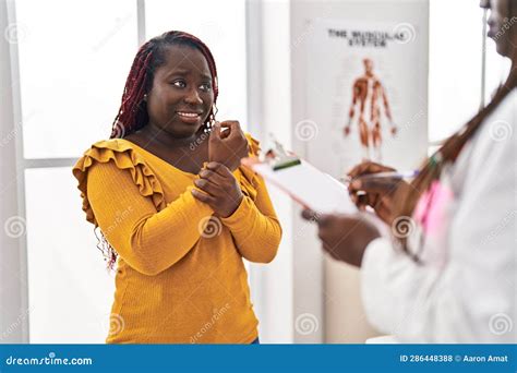 African American Women Doctor And Patient Having Consultation At Clinic