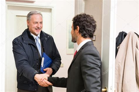 Businessman welcoming guest — Stock Photo © minervastock #90822764