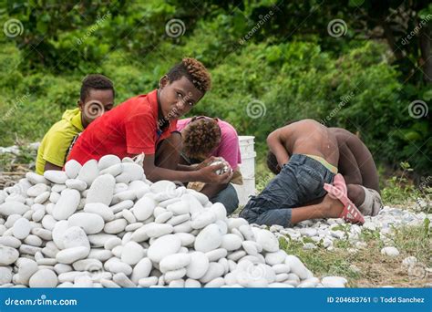 Dramatic Image Of Dominican Children Working On The Caribbean Shore