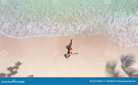 Top View Of Woman In Red Bikini And Relaxation As Lying On Sand During