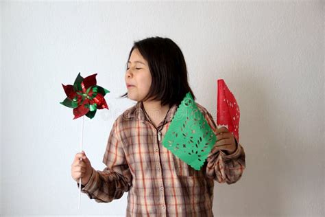 10 Year Old Latina Hispanic Girl Plays With Green White And Red Pennant Flags And Pinwheel To