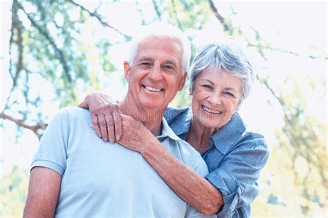 Happy Old Couple Smiling In A Park On A Sunny Day Ad Smiling